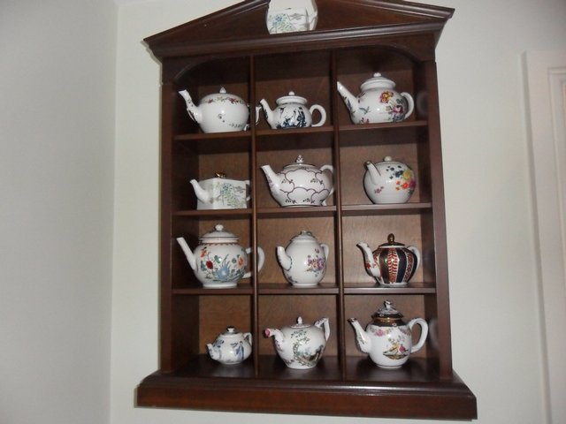 Preview of the first image of PORCELAIN TEA POT COLLECTION WITH DISPLAY CABINET.