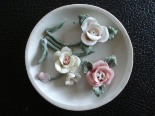 Preview of the first image of COLLECTORS ITEM - SMALL PORCELAIN PLATE WITH RAISED FLOWERS.