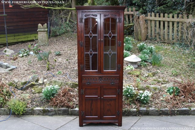 Preview of the first image of OLD CHARM TUDOR BROWN OAK CORNER CABINET DISPLAY CUPBOARD.
