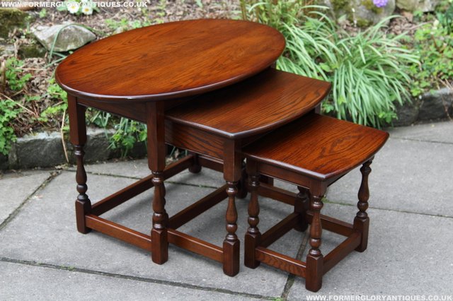 Preview of the first image of OLD CHARM NEST OF 3 OVAL TUDOR OAK COFFEE LAMP TEA TABLES.