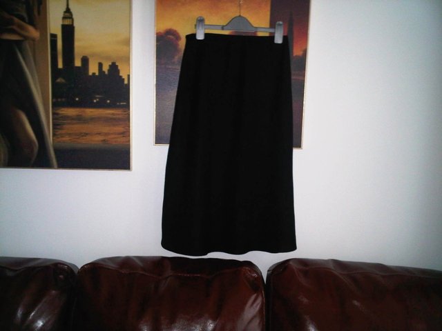 Preview of the first image of Marks & Spencer black skirt lined size 8.