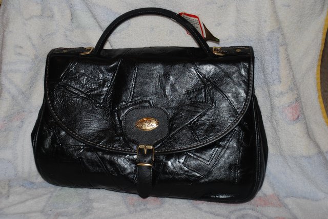 Preview of the first image of Handbag - black leather patchwork exterior.