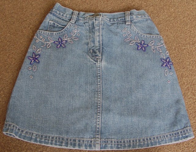 Preview of the first image of BEAUTIFUL GIRLS DENIM SKIRT BY NEXT - AGE 7 YRS.