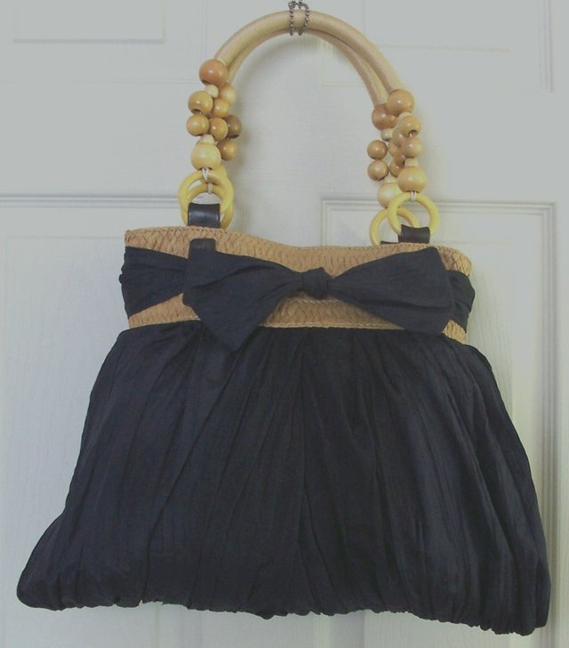 Preview of the first image of LADIES NAVY CRINKLE LOOK HANDBAG WITH BOW DETAIL.
