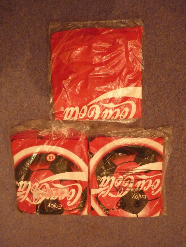 Preview of the first image of Three collectable  Coco Cola T shirts.