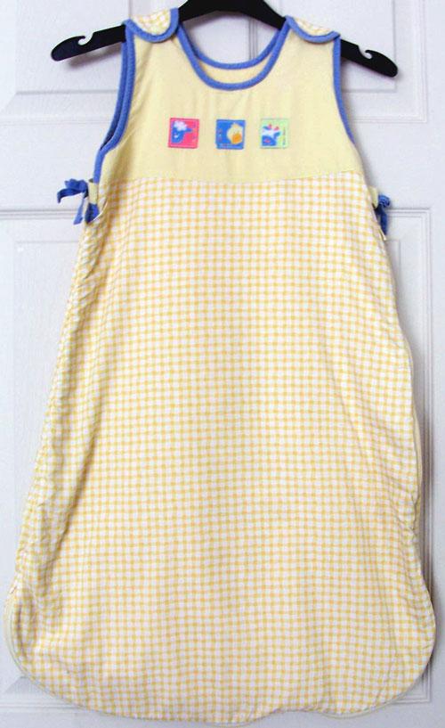 Preview of the first image of GORGEOUS BABIES LEMON CHECK SLEEPING BAG/NEST 6/12M B21.