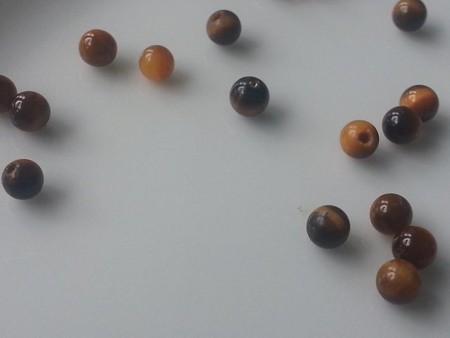 Preview of the first image of TIger Eye beads, half-drilled.