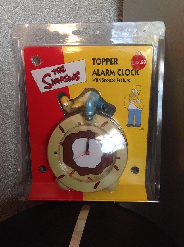 Preview of the first image of The Simpsons Topper Alarm Clock (with snooze feature).
