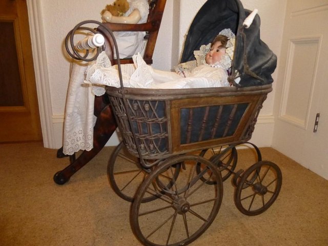 Preview of the first image of ANTIQUE REPRODUCTION DOLLS PRAM.