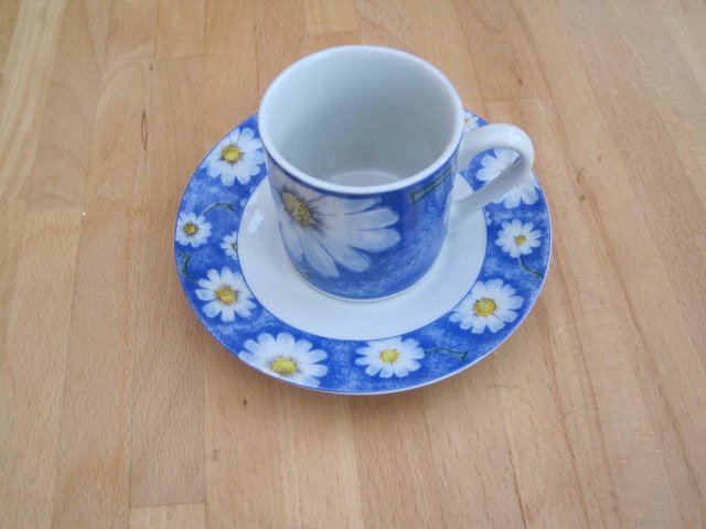 Preview of the first image of White DAISIES on a blue background CUP + SAUCER.
