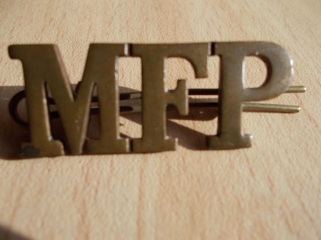 Preview of the first image of Military MFP 1906 Brass shoulder title / cap badge.