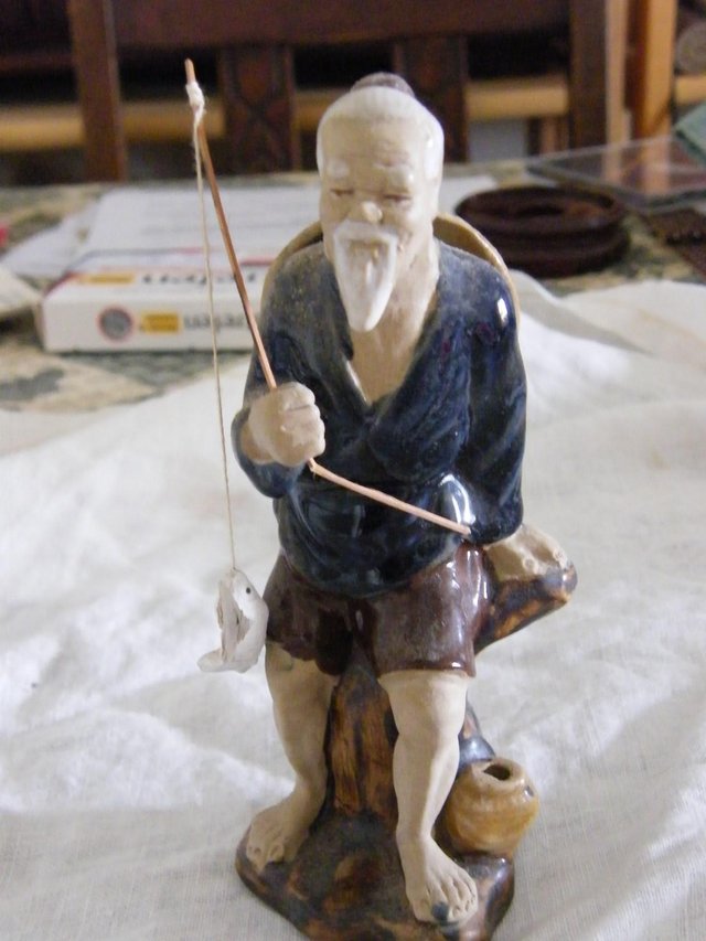 Preview of the first image of Oriental fisherman figurine.