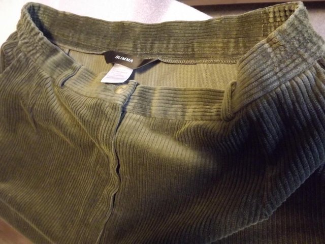 Preview of the first image of Dark green cord trousers size 16.