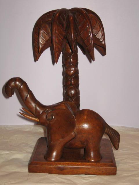 Preview of the first image of Antique Native Hand Carved African Elephant under Palm Tree.