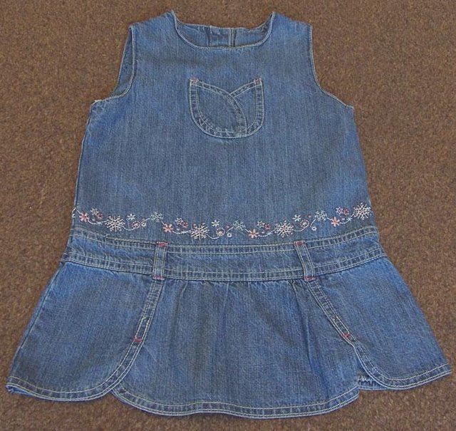 Preview of the first image of PRETTY BABY GIRLS PALE DENIM DRESS - AGE 12/18 MTHS.