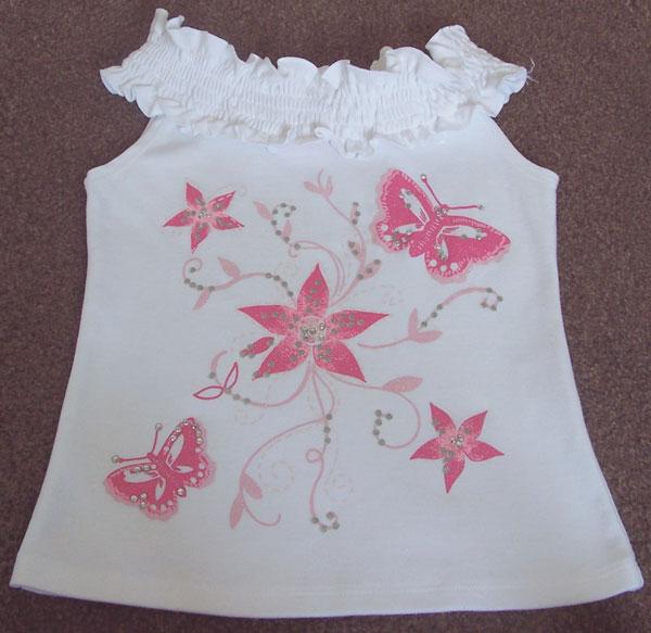 Preview of the first image of GIRLS WHITE TOP WITH BUTTERFLY DIAMANTE DETAIL - AGE 8/9 YRS.