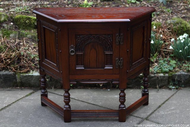 Preview of the first image of AN OLD CHARM TUDOR OAK CANTED CABINET PHONE TABLE SIDEBOARD.