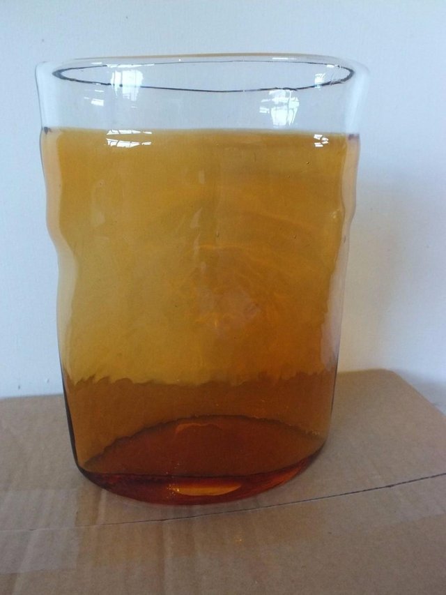 Preview of the first image of RETRO AMBER GLASS VASE - looks like an opening pocket.