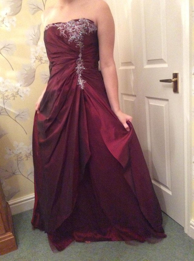 Preview of the first image of Women's size 8 wine red coloured prom dress/ ball gown.
