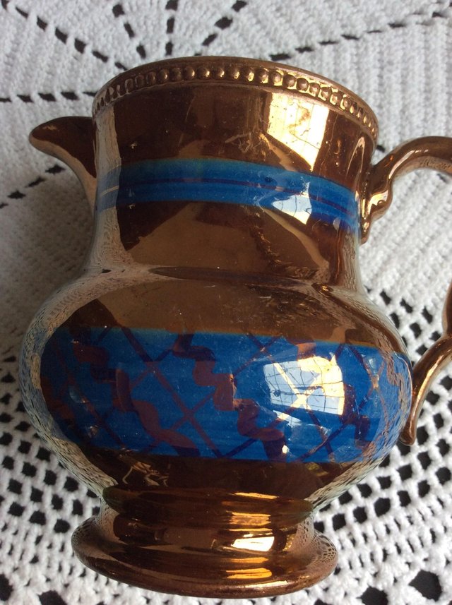 Preview of the first image of Two copper lustre jugs.