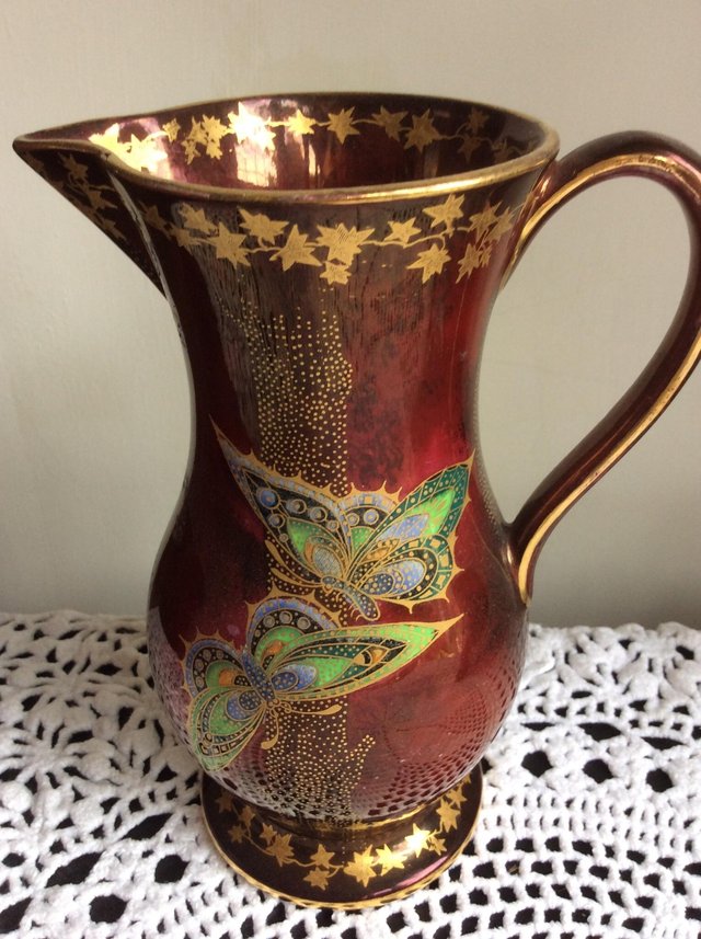 Preview of the first image of A pretty copper lustre jug with butterflies.