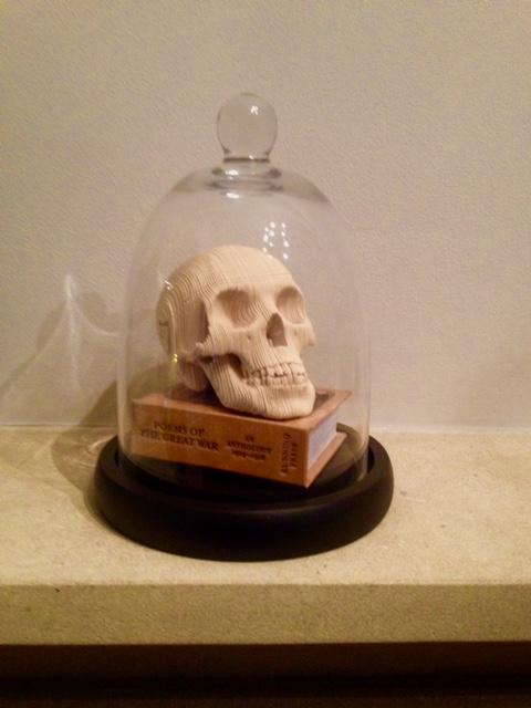 Preview of the first image of Paper skull sculpture under antique glass cloche.