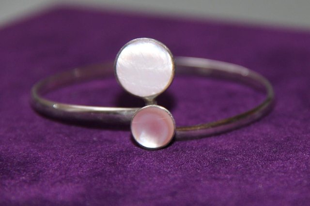 Preview of the first image of Sterling Silver 925 Twist Closure Bracelet With Pink Stones.
