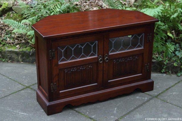 Preview of the first image of AN OLD CHARM TUDOR OAK CORNER TV DVD CD CABINET STAND TABLE.
