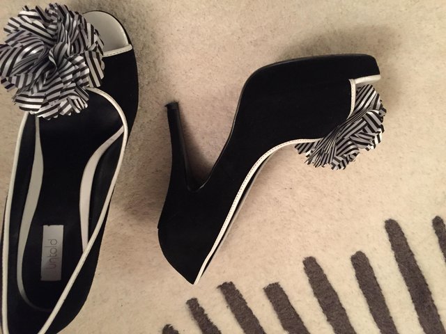Preview of the first image of Black suede platform stiletto shoes.