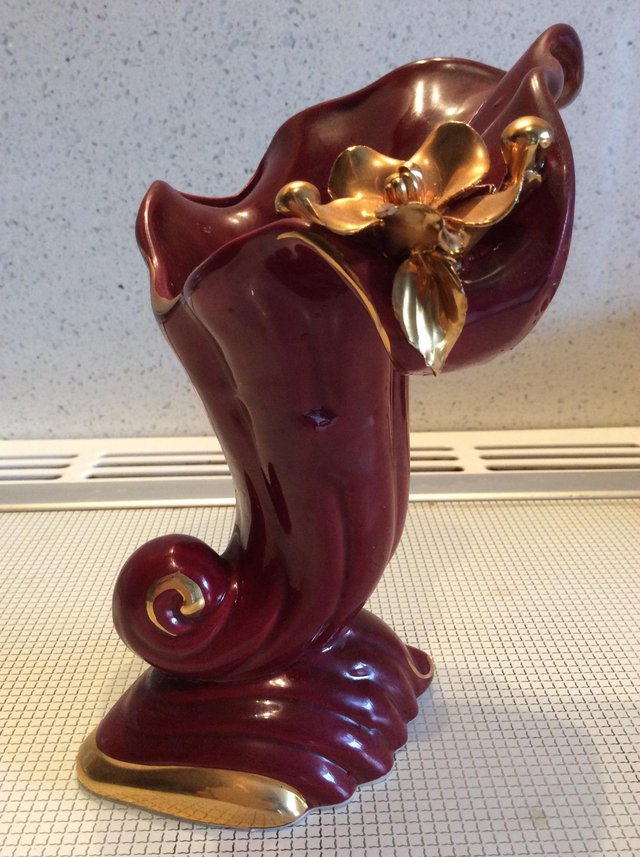 Preview of the first image of Ceramic maroon and gold horn vase.