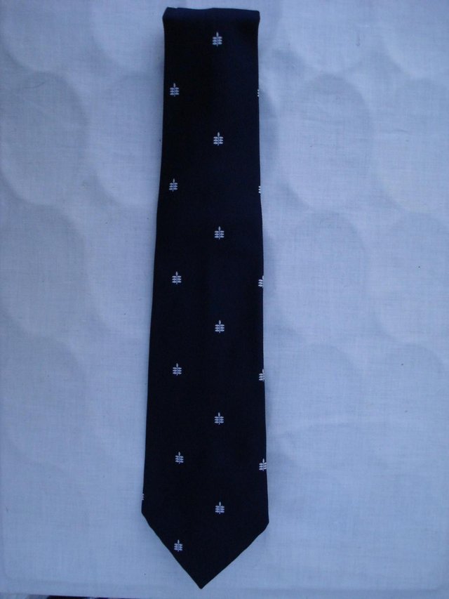 Preview of the first image of NEW MENS POLYESTER ROYAL BLUE TIE WITH WHITE LEAF DESIGN.