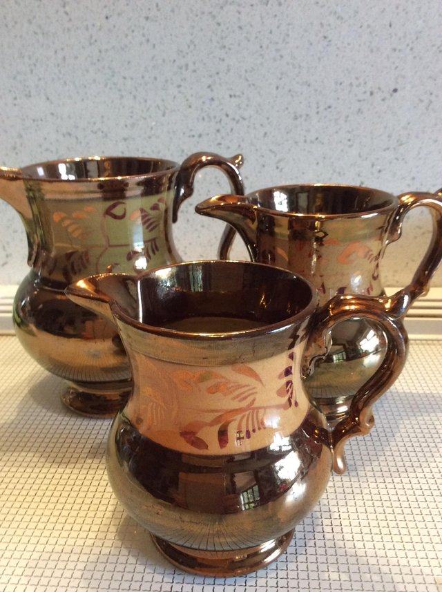 Preview of the first image of Set of Three Antique Copper Lustre Jugs.