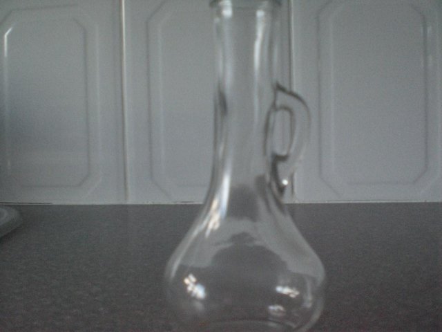 Preview of the first image of Clear Glass vase with small handle for eg  a single Rose or.