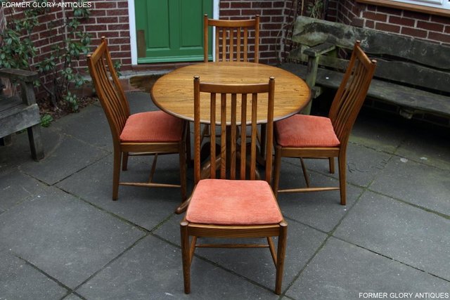 Preview of the first image of ERCOL GOLDEN DAWN CHESTER ROUND DINING TABLE & FOUR CHAIRS.