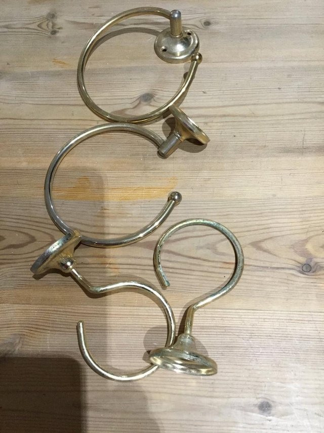 Preview of the first image of Two brass towel rings and two cup holders.
