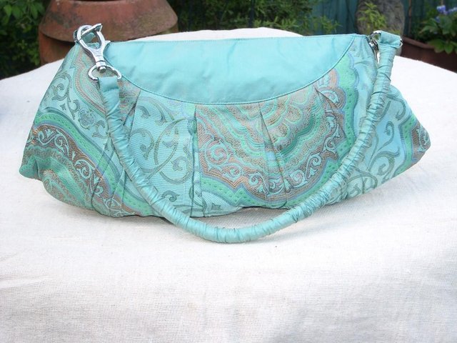 Preview of the first image of Turquoise Pleated Silk Handbag/Clutch – New With Tags.