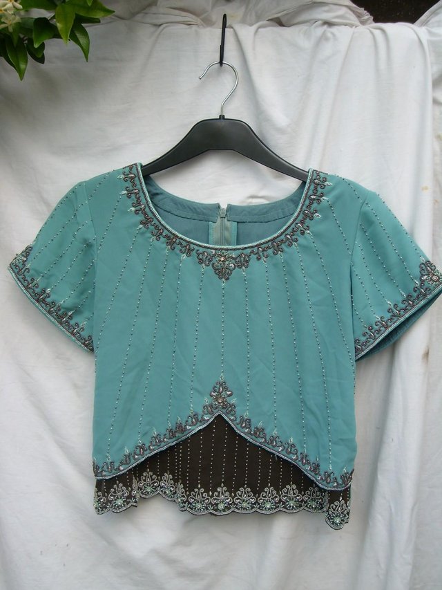 Preview of the first image of Layer Fronted Green Beaded Top - Size 10-12.