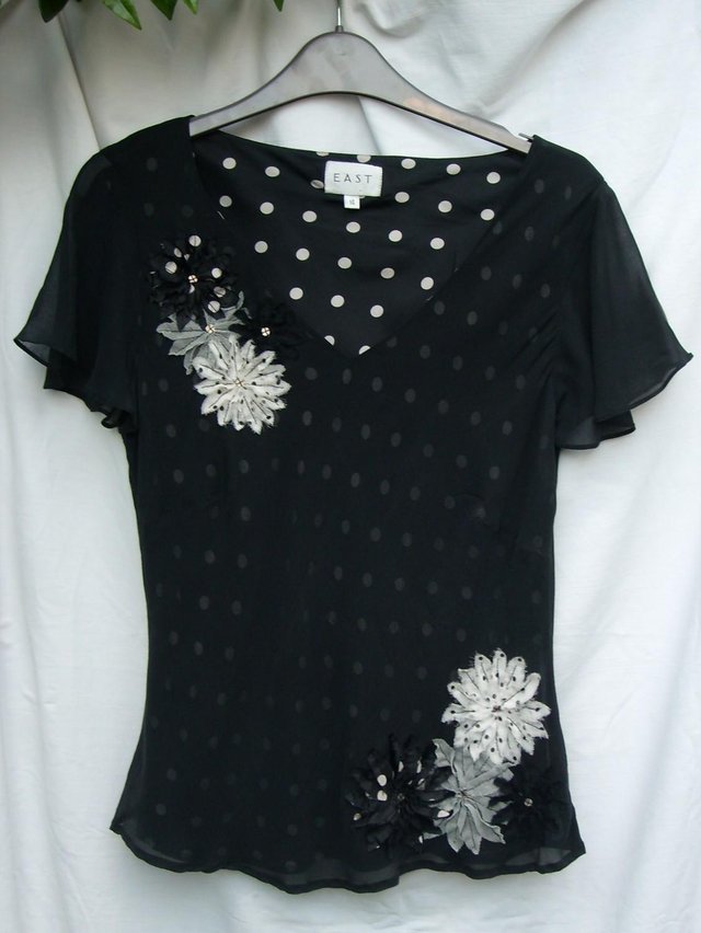 Preview of the first image of Cute EAST Black & White Silk Top– Size 14.