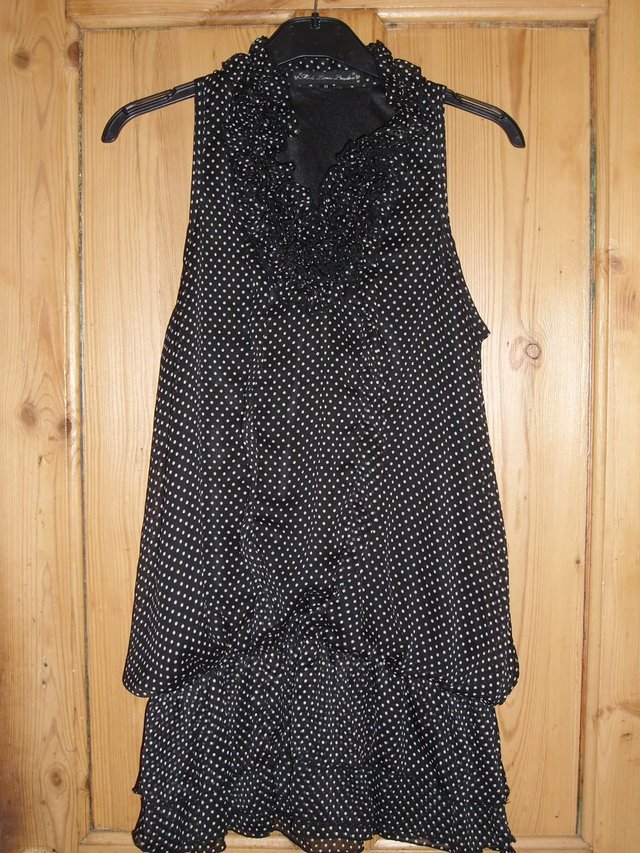 Preview of the first image of MELA LOVES LONDON Black Spotty Ruffle Dress – Size M/12.