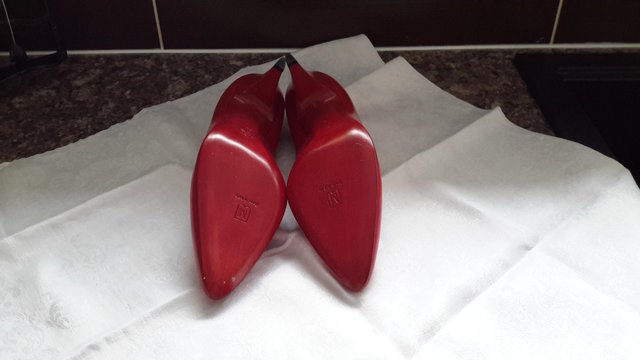 Preview of the first image of Bruno Magli leather red court shoes.