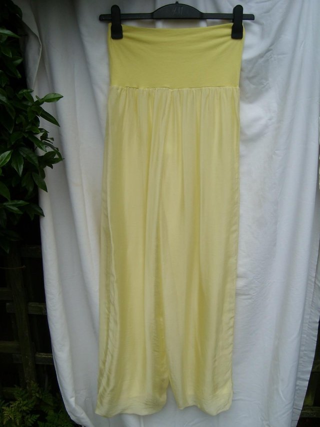 Preview of the first image of MADE IN ITALY Yellow Silk Harem Type Trousers – Size 8.