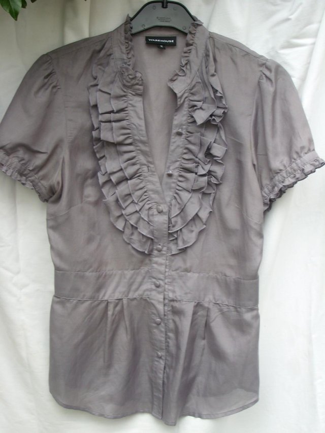 Preview of the first image of WAREHOUSE Grey Cotton/Silk Ruffle Shirt – Size 12.