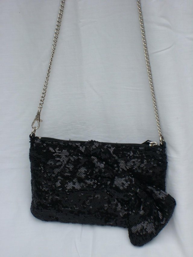 Preview of the first image of Black Sequin Cross Body Evening Handbag With Bow Detail.