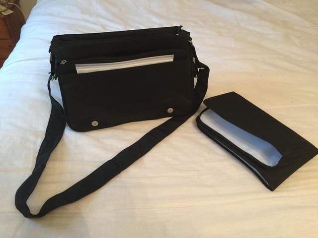 Preview of the first image of Brand New black baby changing bag with changing mat.