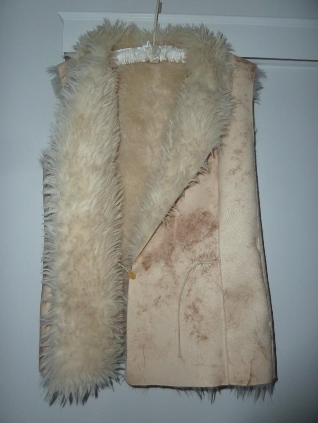 Preview of the first image of Designer fur lined sleeveless jacket size 14.