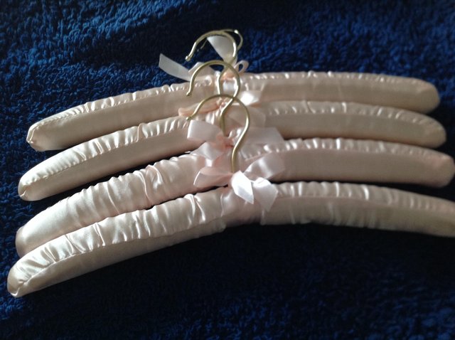 Preview of the first image of 4 NEW, SATIN COAT HANGERS.