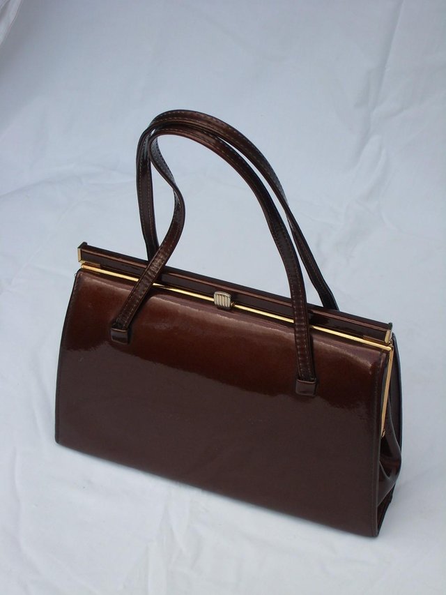Preview of the first image of Vintage 1950’s GOLD CROSS Bronze Leather Kelly Handbag.