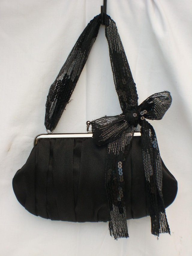 Preview of the first image of ACCESSORIZE Black Satin Snap Top Eve Handbag & Ribbon Handle.