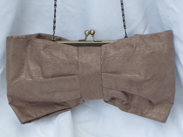 Preview of the first image of ACCESSORIZE Snap Top Bow Handbag/Clutch.
