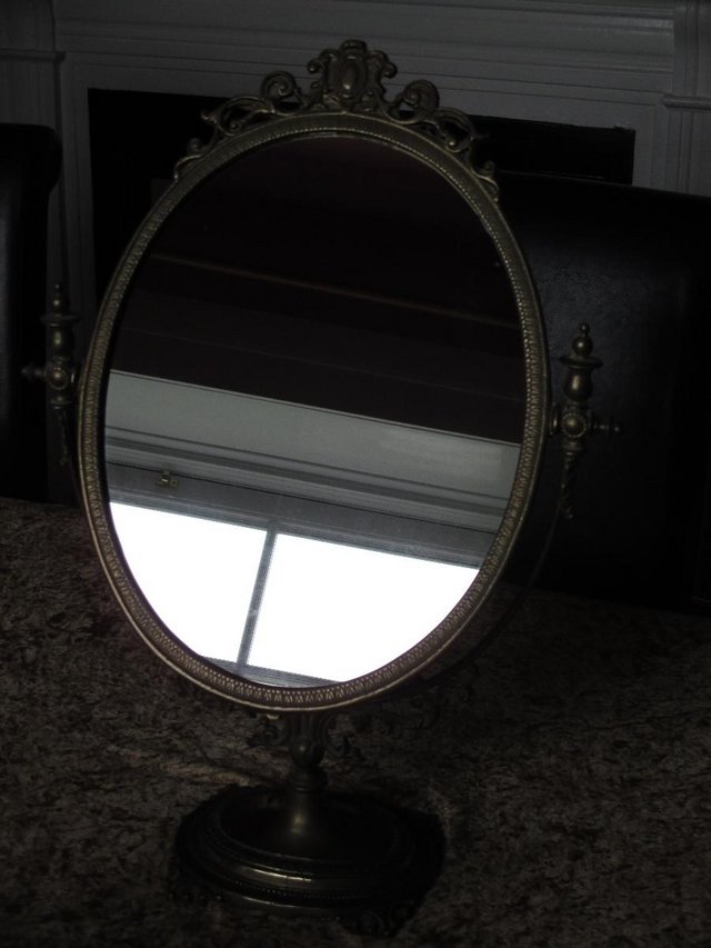 Preview of the first image of Vintage brass oval freestanding mirror.